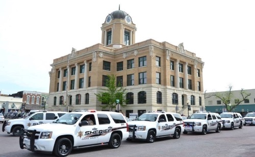 Six Sheriff Office Patrol division vehicles parked outside the Cooke County Courthouse.